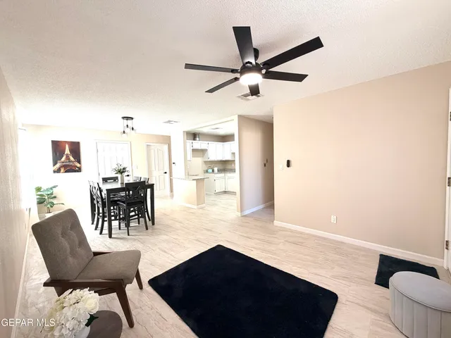 a view of a livingroom with furniture and a ceiling fan