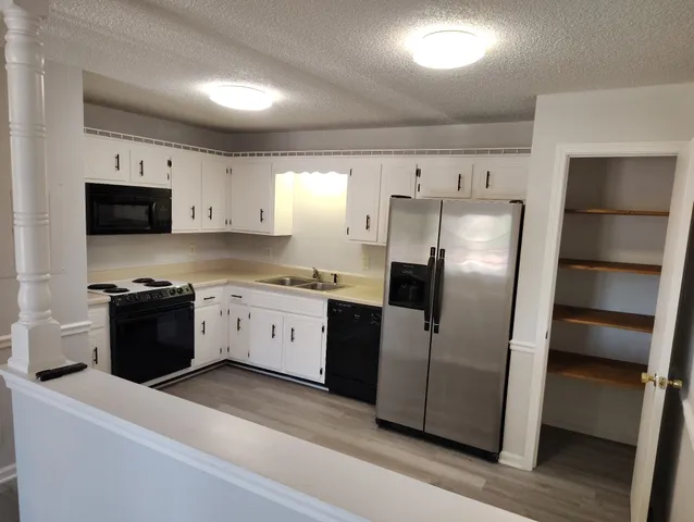 a kitchen with stainless steel appliances a refrigerator sink and microwave