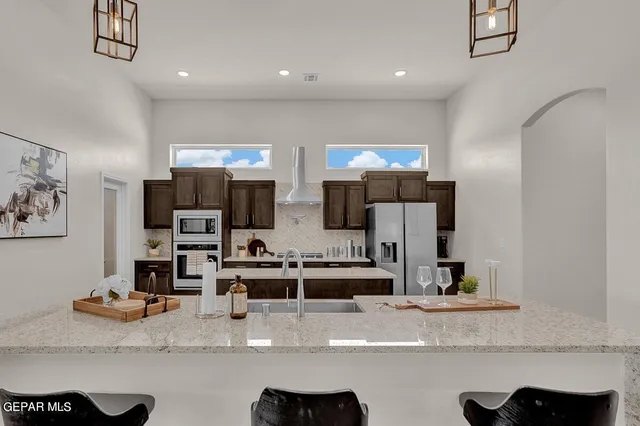 a bathroom with a granite countertop sink a mirror and vanity