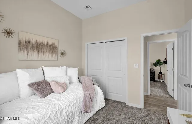 a bedroom with a bed and a potted plant
