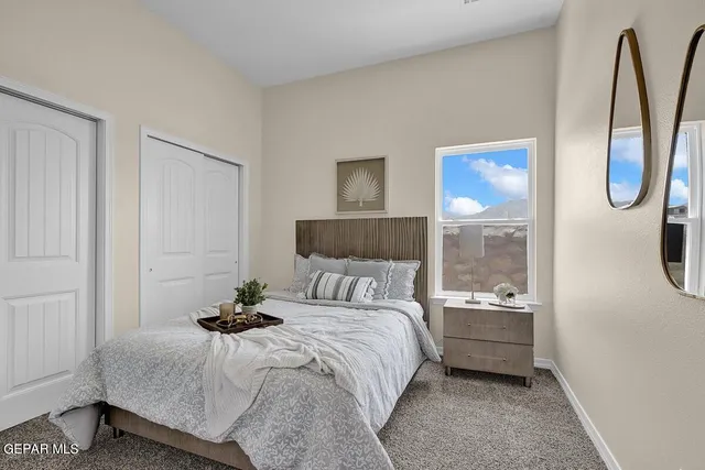 a bedroom with a bed and a potted plant