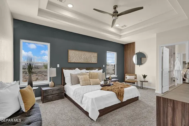 a living room with furniture a flat screen tv and a chandelier