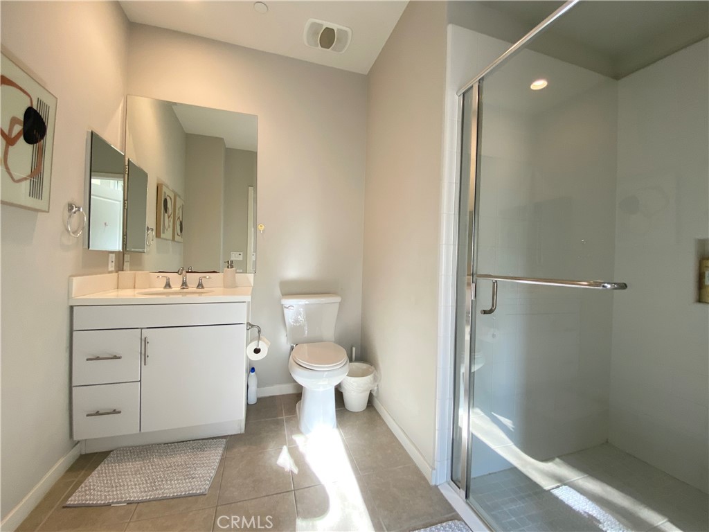 57 Bronze Leaf Irvine, CA 92620 - Photo 14 of 35 a bathroom with a toilet a sink and a mirror