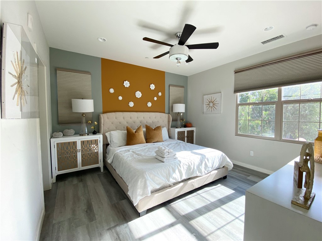 57 Bronze Leaf Irvine, CA 92620 - Photo 18 of 35 a bedroom with a large bed and a chandelier