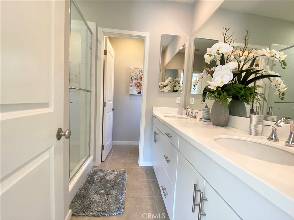 57 Bronze Leaf Irvine, CA 92620 - Photo 20 of 35 a bathroom with a sink a vanity and a shower
