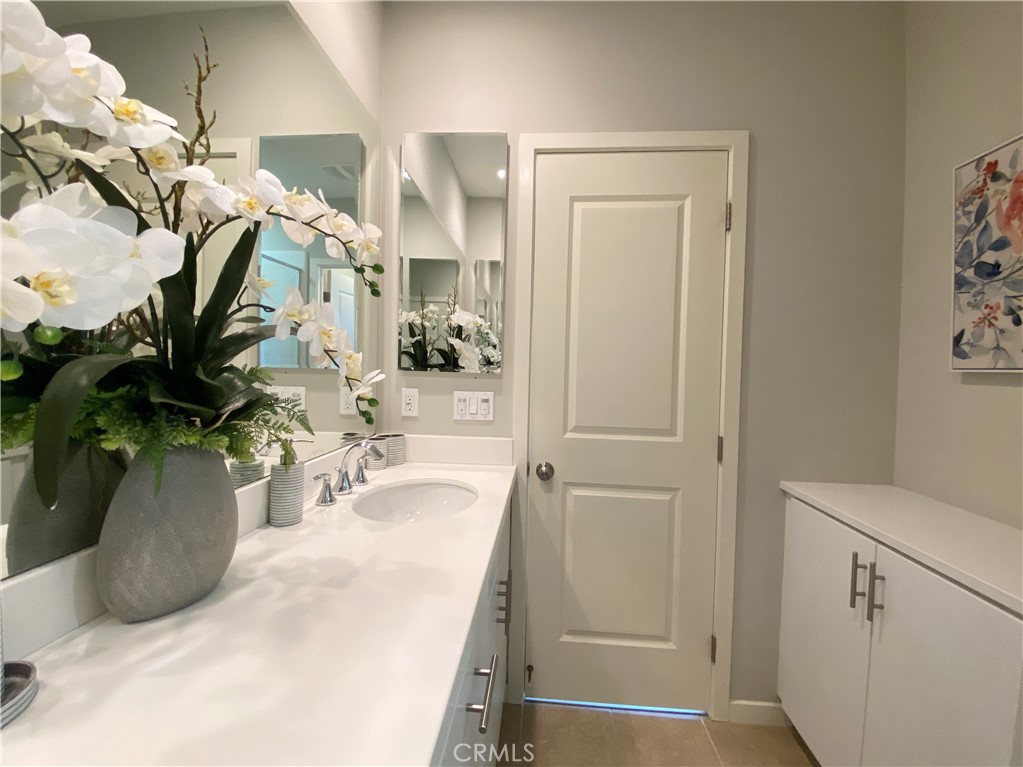57 Bronze Leaf Irvine, CA 92620 - Photo 21 of 35 a bathroom with a sink a mirror and a potted plant