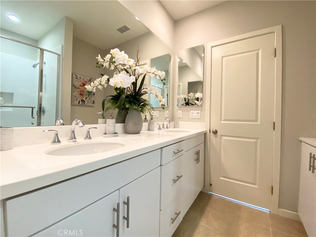 57 Bronze Leaf Irvine, CA 92620 - Photo 23 of 35 a bathroom with a sink vanity and a mirror