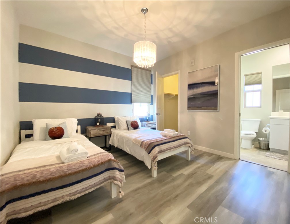 57 Bronze Leaf Irvine, CA 92620 - Photo 29 of 35 a bedroom with two beds and a chandelier
