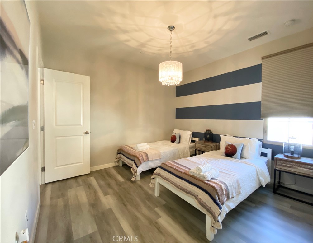 57 Bronze Leaf Irvine, CA 92620 - Photo 30 of 35 a bedroom with two beds and chandelier