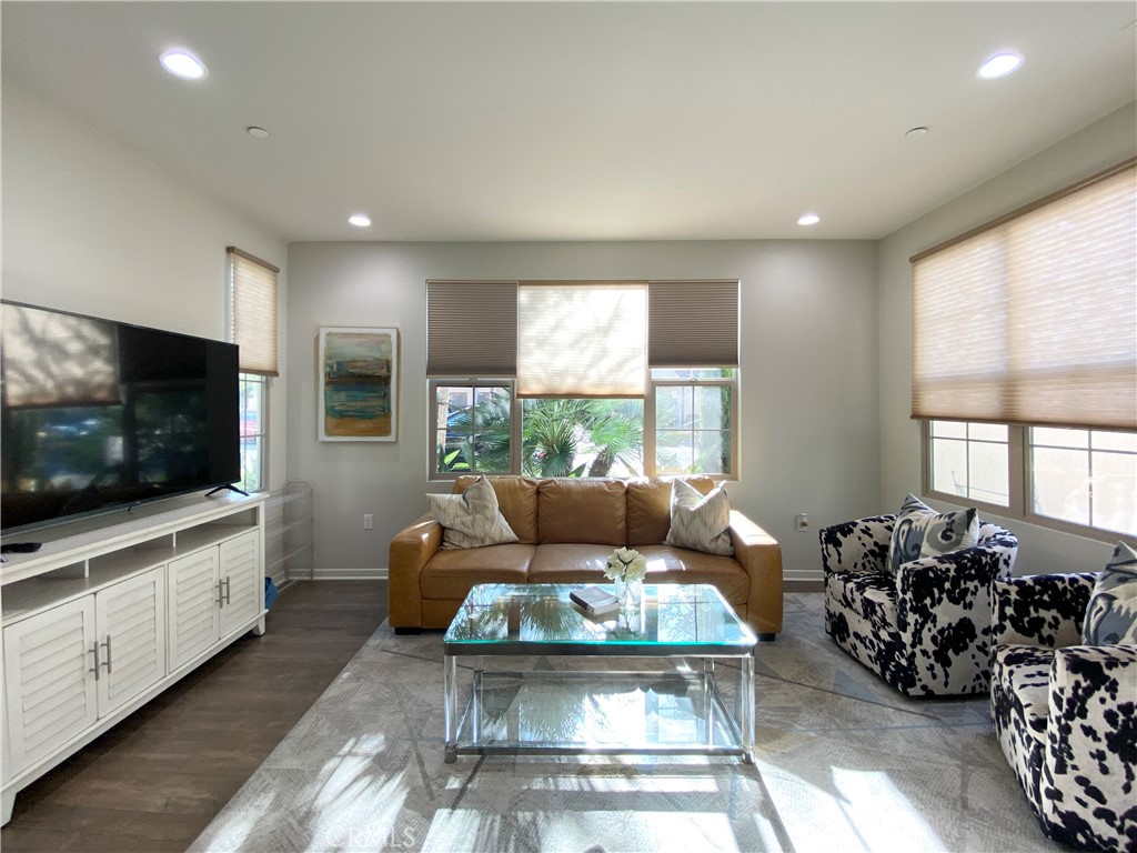 57 Bronze Leaf Irvine, CA 92620 - Photo 3 of 35 a living room with furniture a flat screen tv and a large window