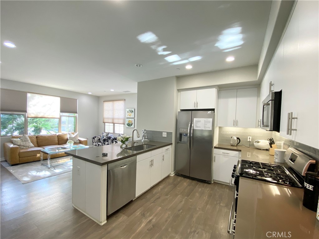 57 Bronze Leaf Irvine, CA 92620 - Photo 10 of 35 a kitchen with sink refrigerator and couches