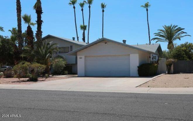 3530 South Poplar Street Tempe, AZ 85282 - Photo 2 of 4 a front view of a house with a yard and garage