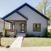 a view of house with yard