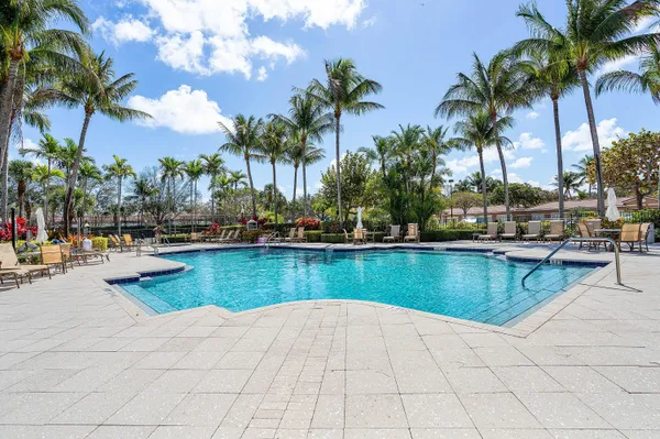 a view of swimming pool with outdoor seating and plants