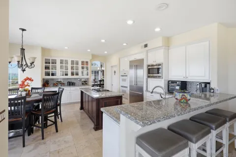 a large kitchen with a table and chairs