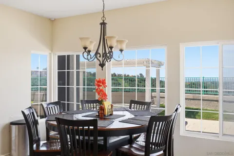 a kitchen with a dining table chairs cabinets and stainless steel appliances
