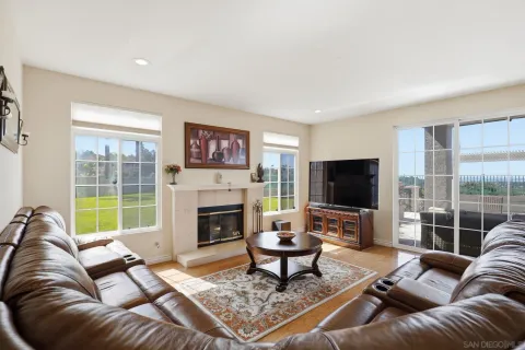 a view of a a dining room with furniture window and wooden floor