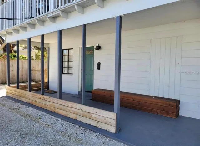 a bedroom with a bed and large window