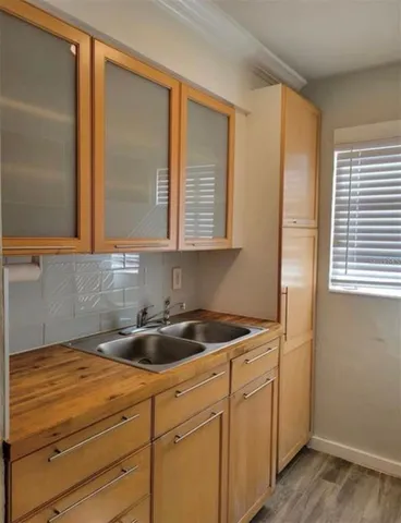 a kitchen with a sink and cabinets