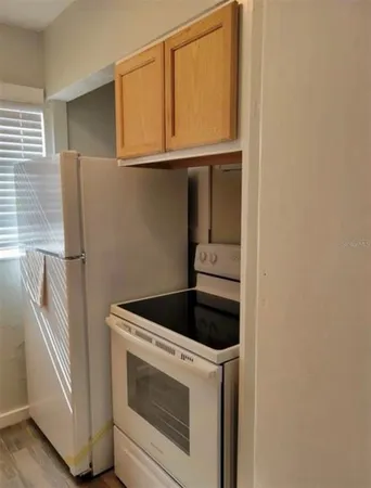 a kitchen with a stove and a refrigerator