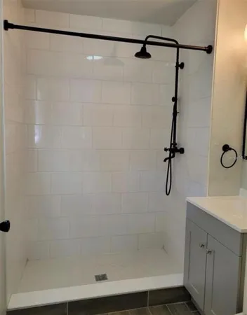 a bathroom with a shower and a sink