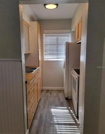 a bathroom with a sink a toilet and a window