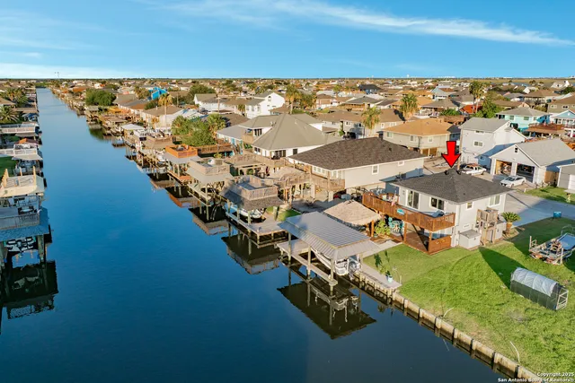 an aerial view of residential houses with outdoor space