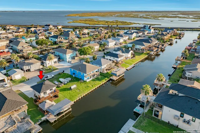 an aerial view of a house with a lake view