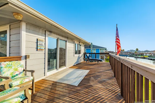a view of a balcony with wooden floor and fence