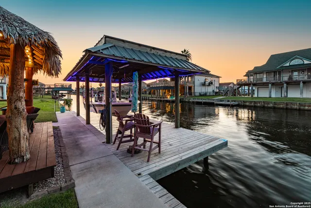 a view of a house with wooden deck and lake