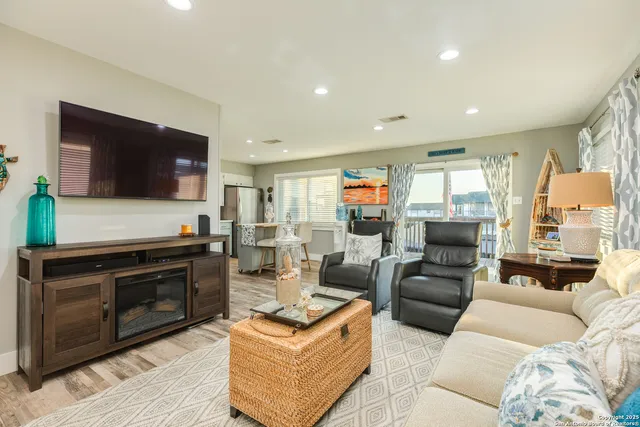 a view of kitchen with granite countertop lots of counter top space and wooden floor
