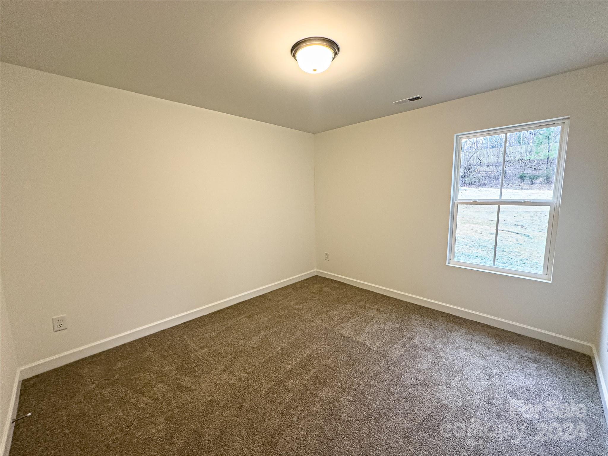 650 Sedgefield Street Southwest Concord, NC 28025 - Photo 11 of 15 an empty room with a empty space and windows