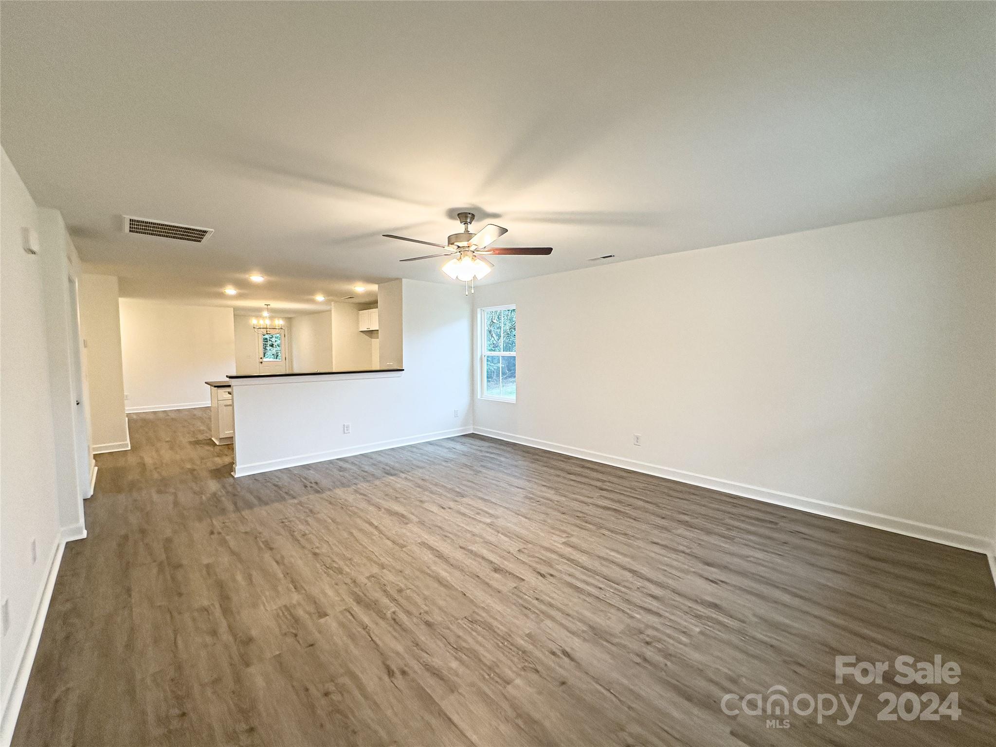 650 Sedgefield Street Southwest Concord, NC 28025 - Photo 4 of 15 a view of a kitchen with wooden floor and a kitchen