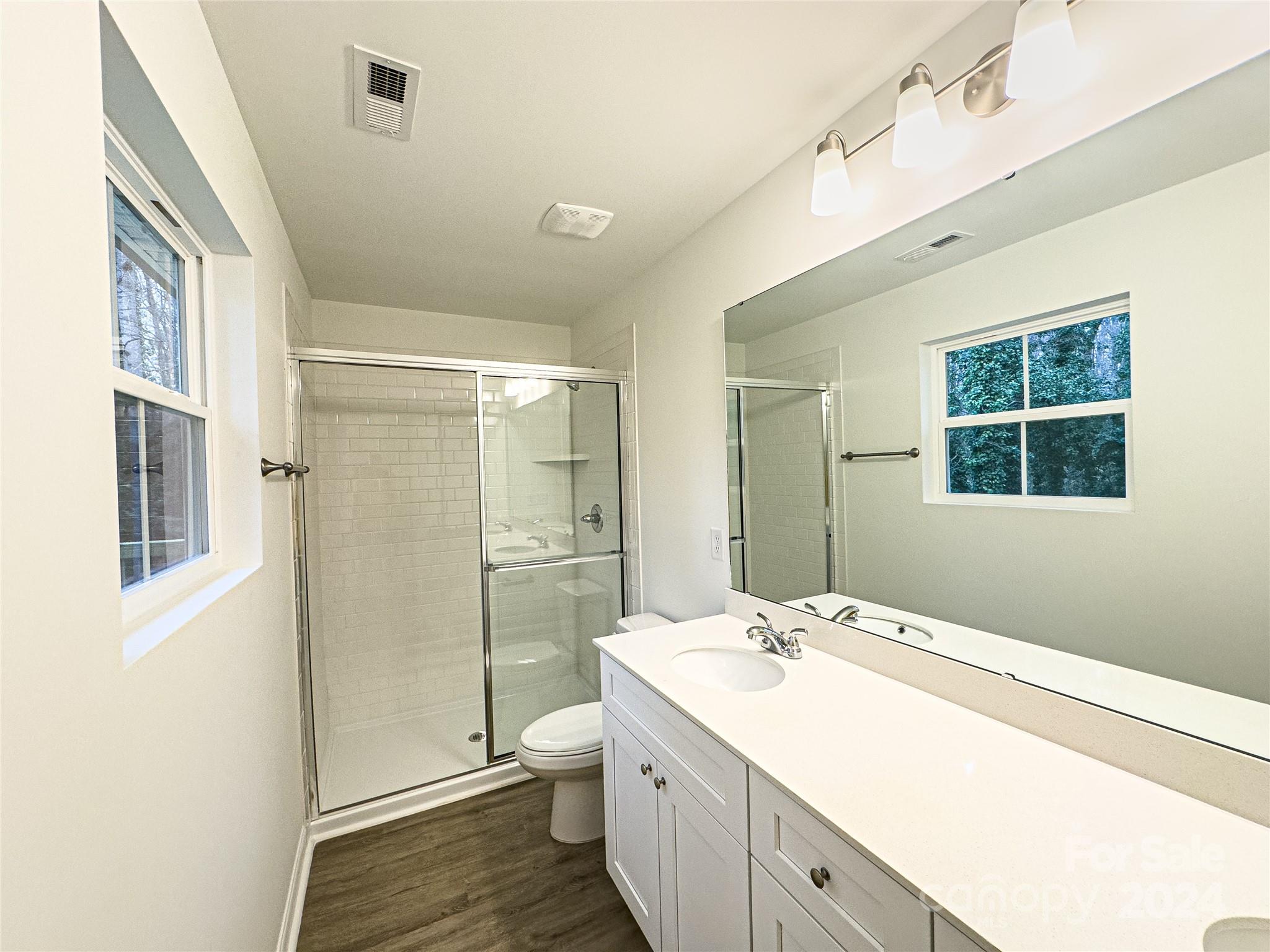 650 Sedgefield Street Southwest Concord, NC 28025 - Photo 7 of 15 a spacious bathroom with a granite countertop sink toilet and shower