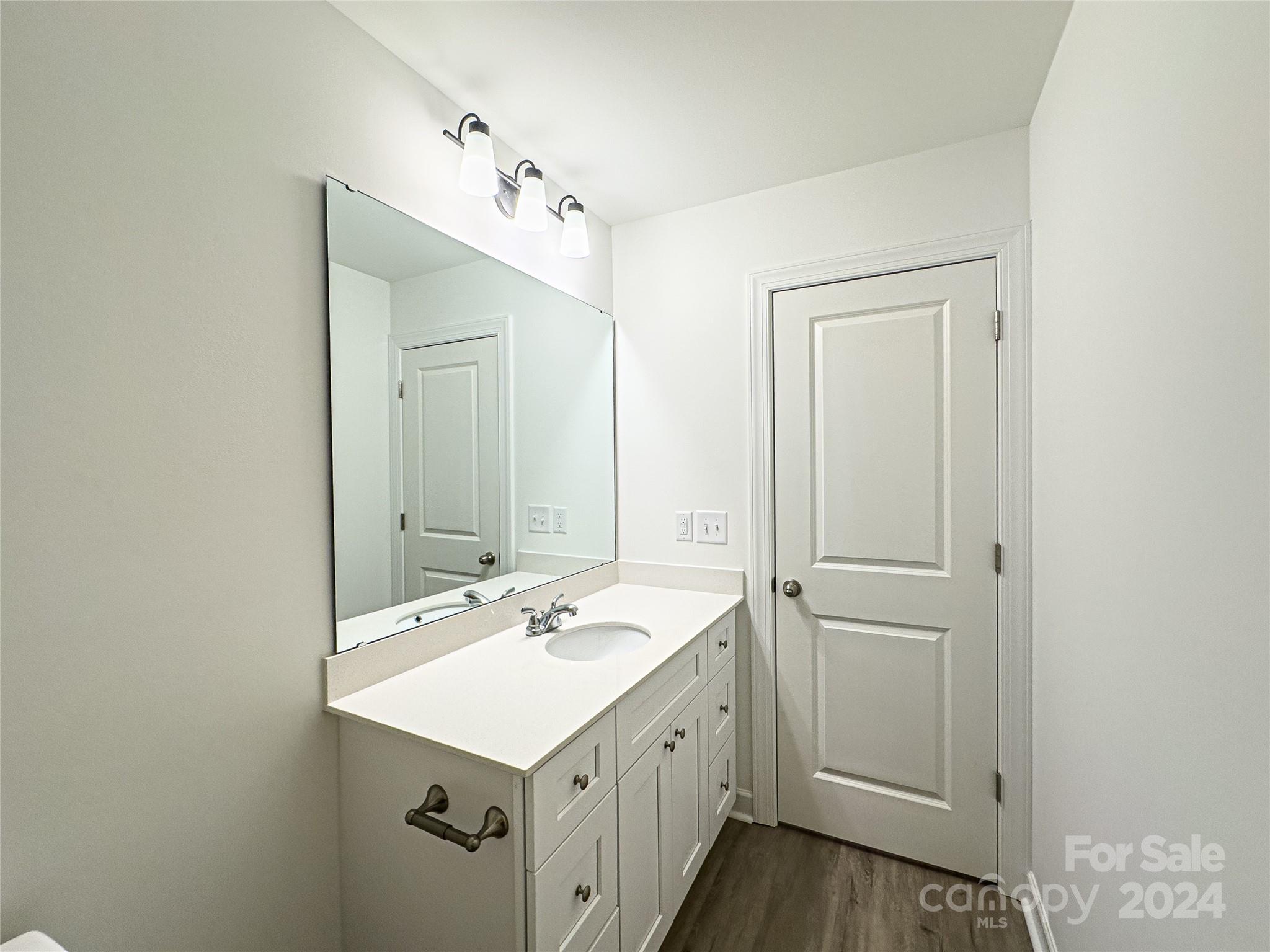 650 Sedgefield Street Southwest Concord, NC 28025 - Photo 8 of 15 a bathroom with a sink a toilet and a mirror