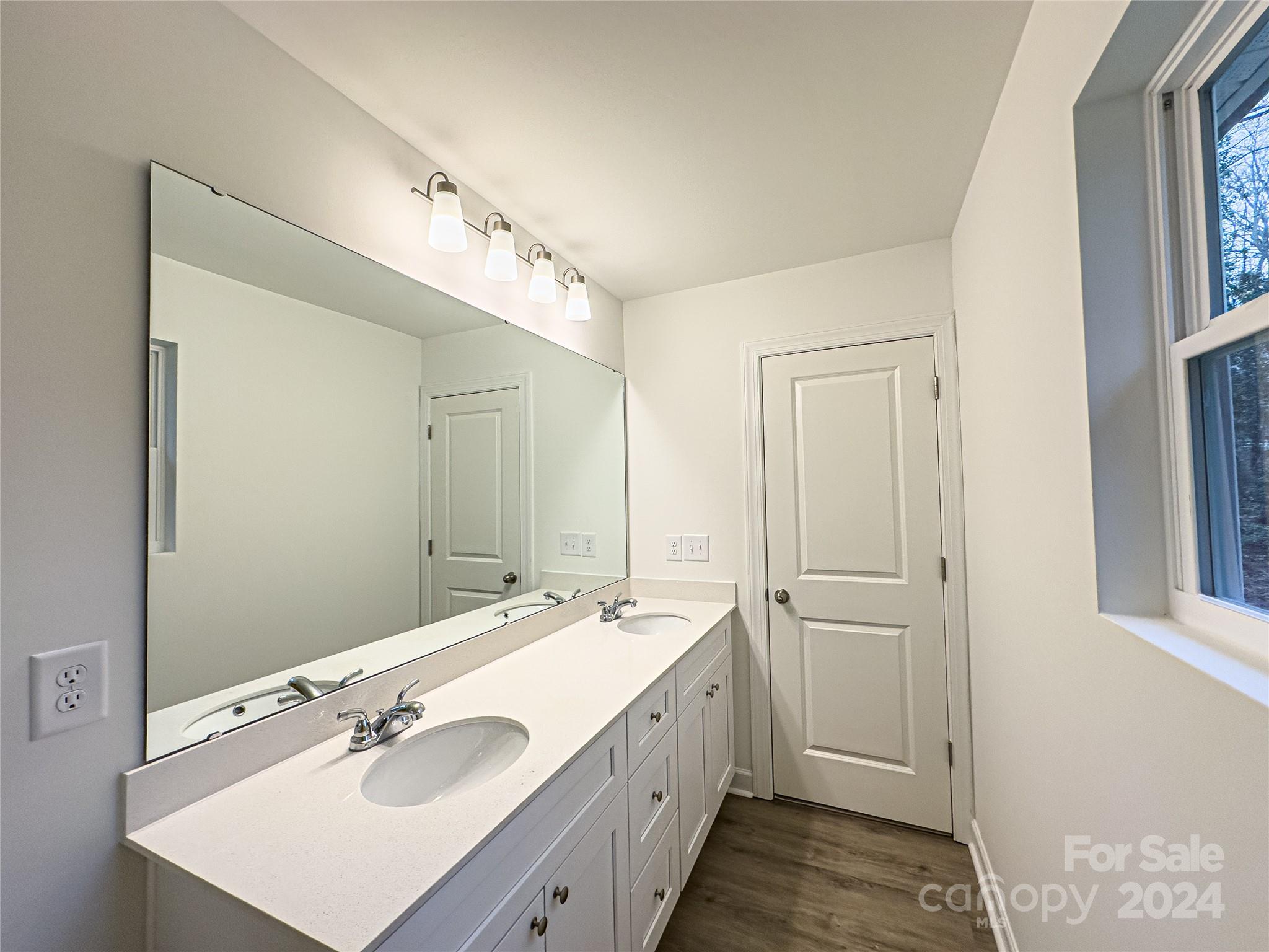 650 Sedgefield Street Southwest Concord, NC 28025 - Photo 9 of 15 a bathroom with a double vanity sink a mirror and a shower