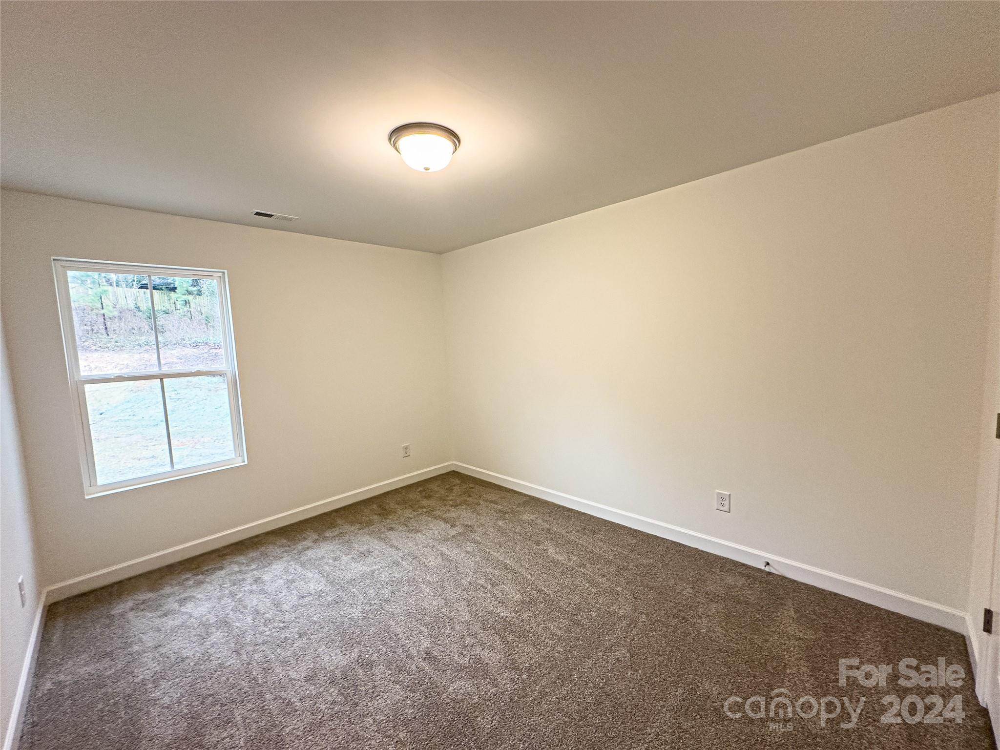 650 Sedgefield Street Southwest Concord, NC 28025 - Photo 10 of 15 an empty room with a empty space and a window