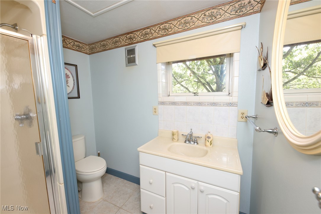 115 Carol Road Wellsburg, WV 26070 - Photo 31 of 36 Full bath with vanity, a shower stall, light tile patterned floors, and tasteful backsplash