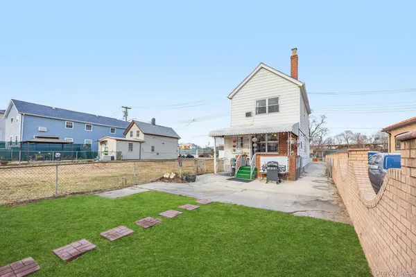 a view of a house with a yard and sitting area