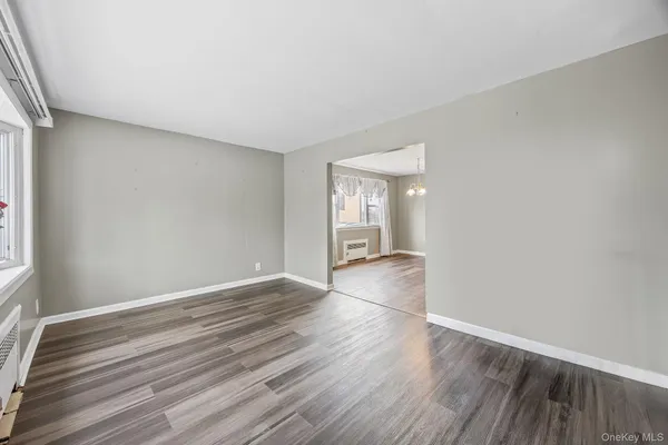 a view of wooden floor and windows in an empty room
