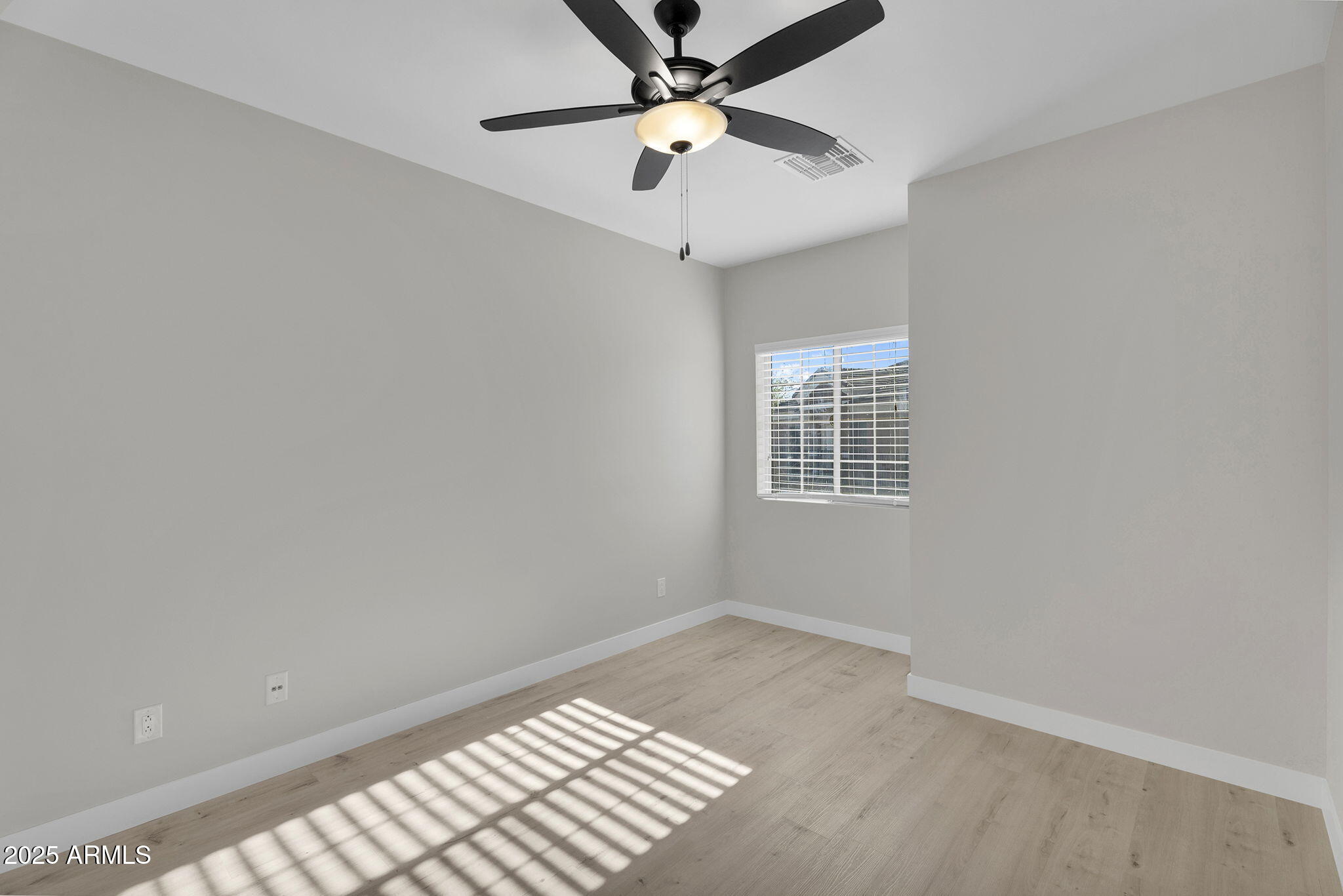 854 South San Marcos Drive, Unit 7C Apache Junction, AZ 85120 - Photo 11 of 48 an empty room with a window and a ceiling fan