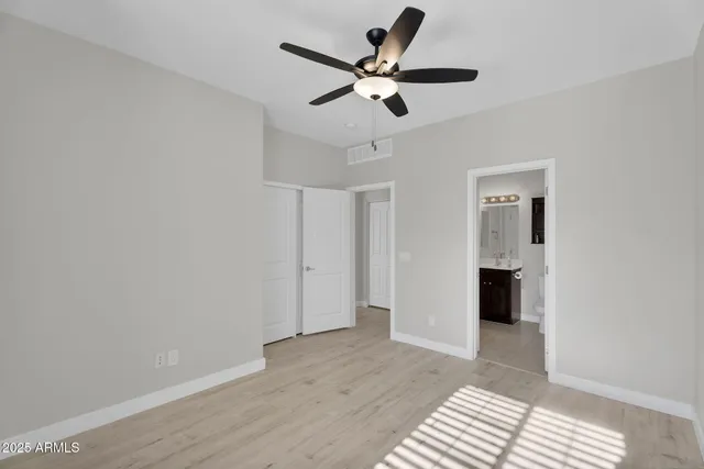 a view of a livingroom with a window and wooden floor