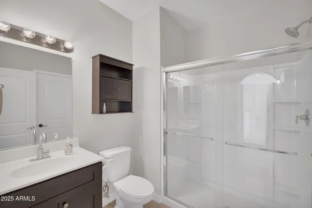 a view of an empty room with a window and a ceiling fan