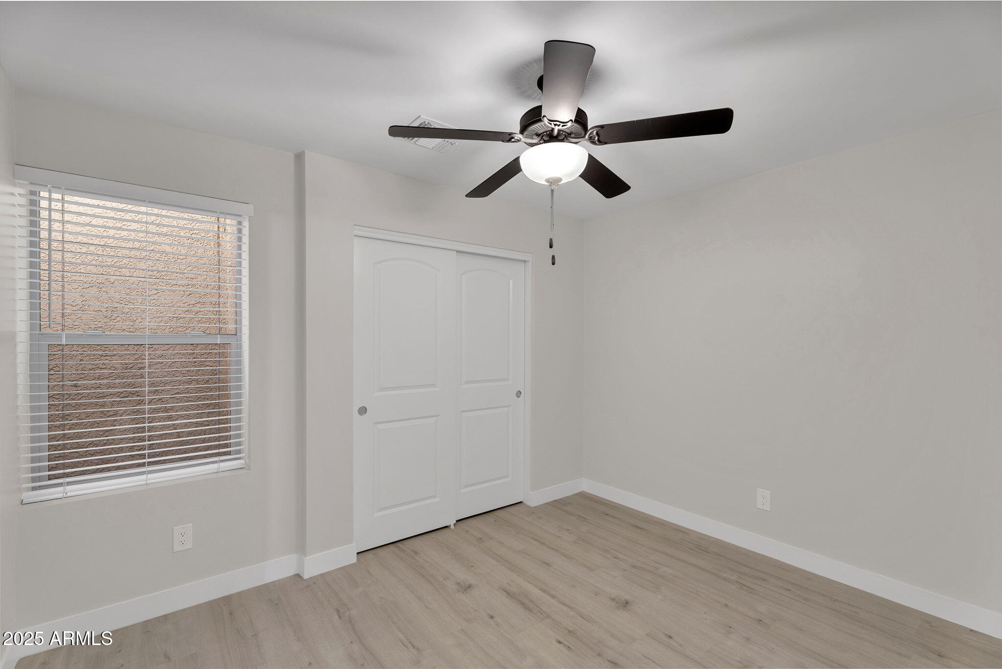 854 South San Marcos Drive, Unit 7C Apache Junction, AZ 85120 - Photo 19 of 48 a view of empty room with wooden floor and fan