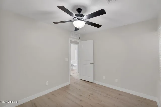 a view of a room with wooden floor closet and windows
