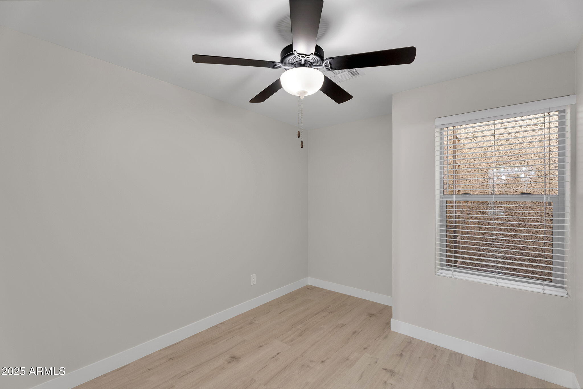 854 South San Marcos Drive, Unit 7C Apache Junction, AZ 85120 - Photo 21 of 48 a view of empty room with wooden floor and fan