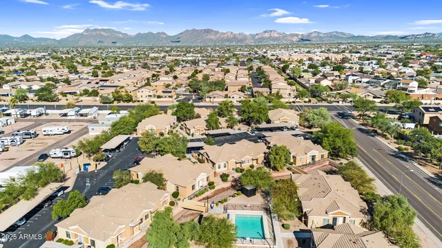 an aerial view of residential houses with outdoor space and ocean view