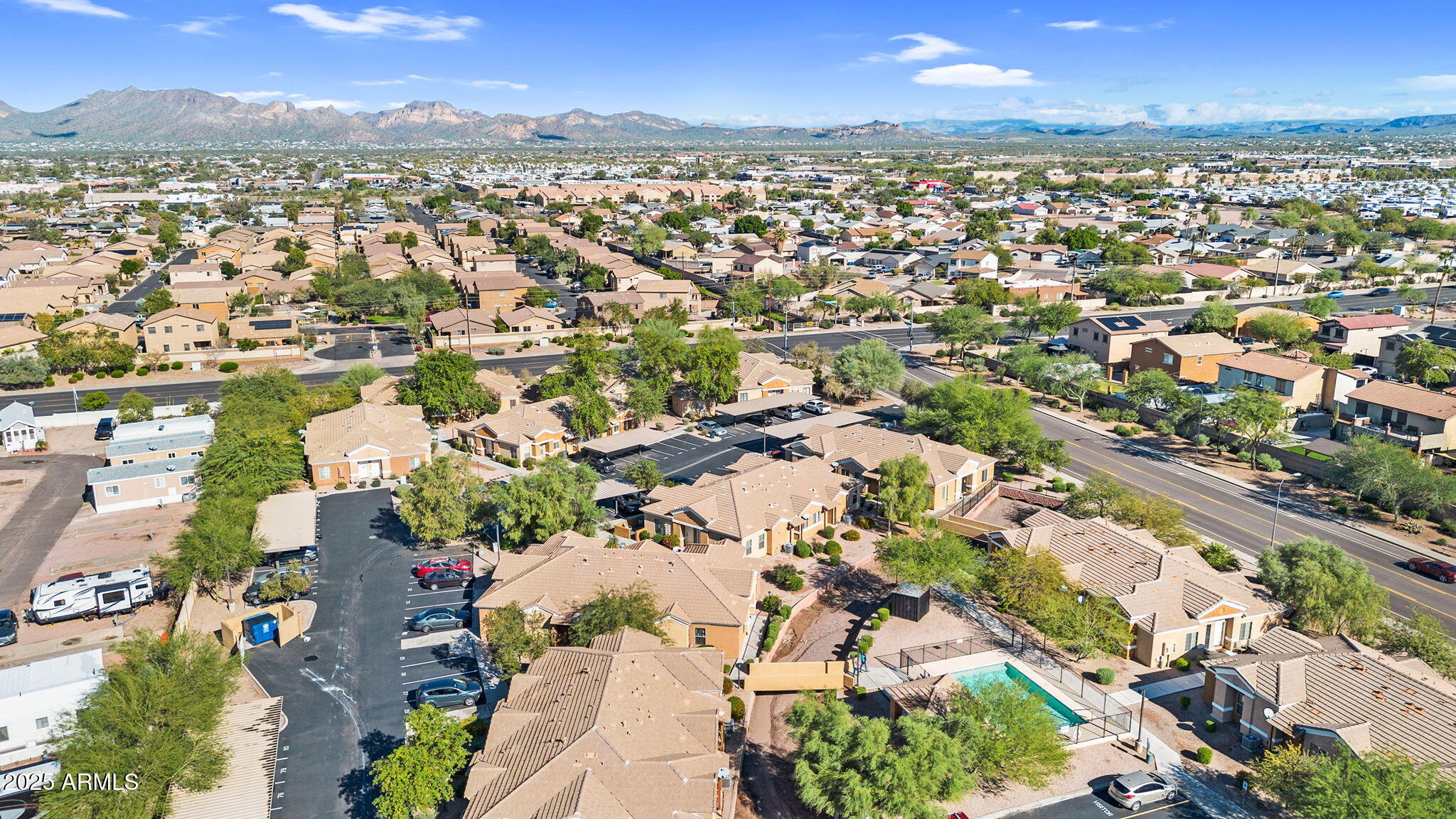854 South San Marcos Drive, Unit 7C Apache Junction, AZ 85120 - Photo 40 of 48 an aerial view of a city with lots of residential buildings and mountain view in back