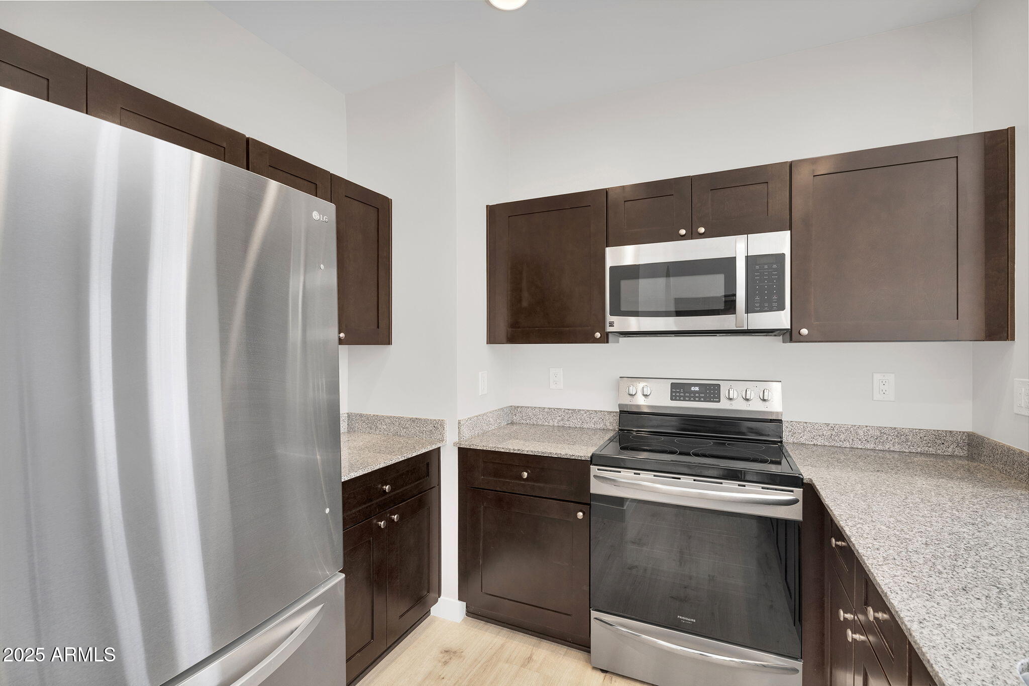 854 South San Marcos Drive, Unit 7C Apache Junction, AZ 85120 - Photo 7 of 48 a kitchen with stainless steel appliances granite countertop a refrigerator and a stove top oven