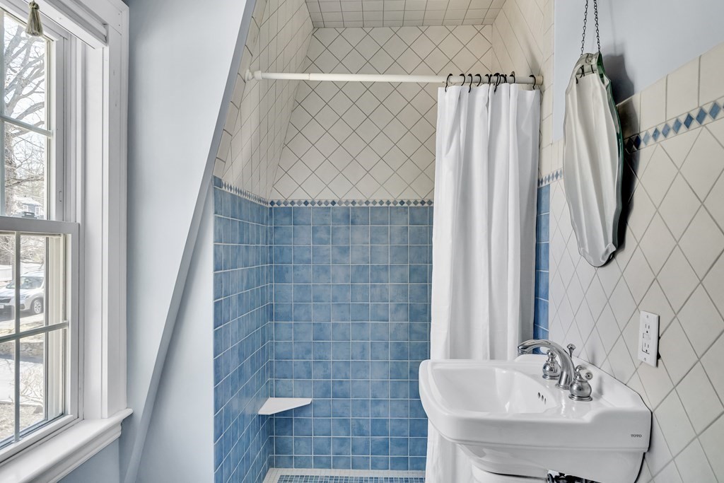 36 Sunset Road Wellesley, MA 02482 - Photo 22 of 30 a bathroom with a sink a mirror and a shower
